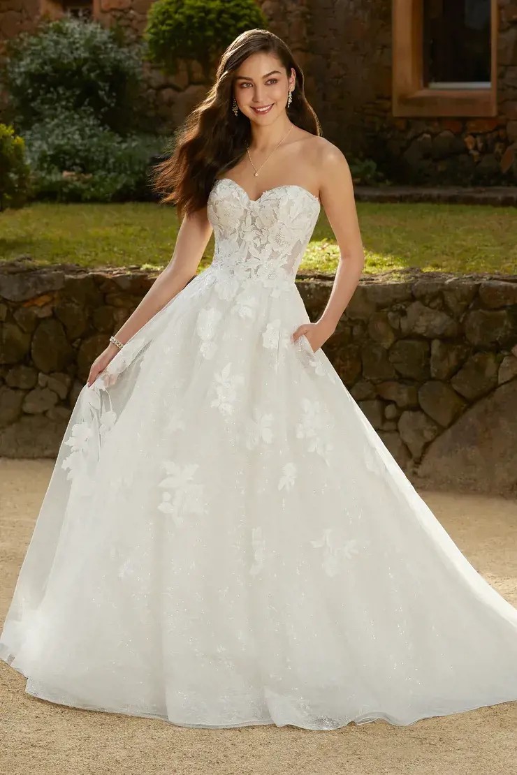 Model wearing a gown by Sophia Tolli